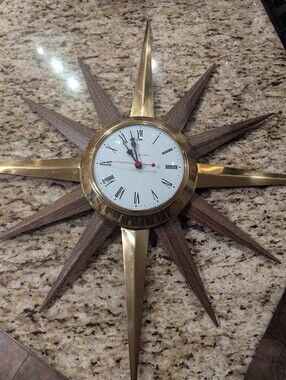 Mid century Modern electric starburst clock by Ingraham gold &  Wood Grain Metal